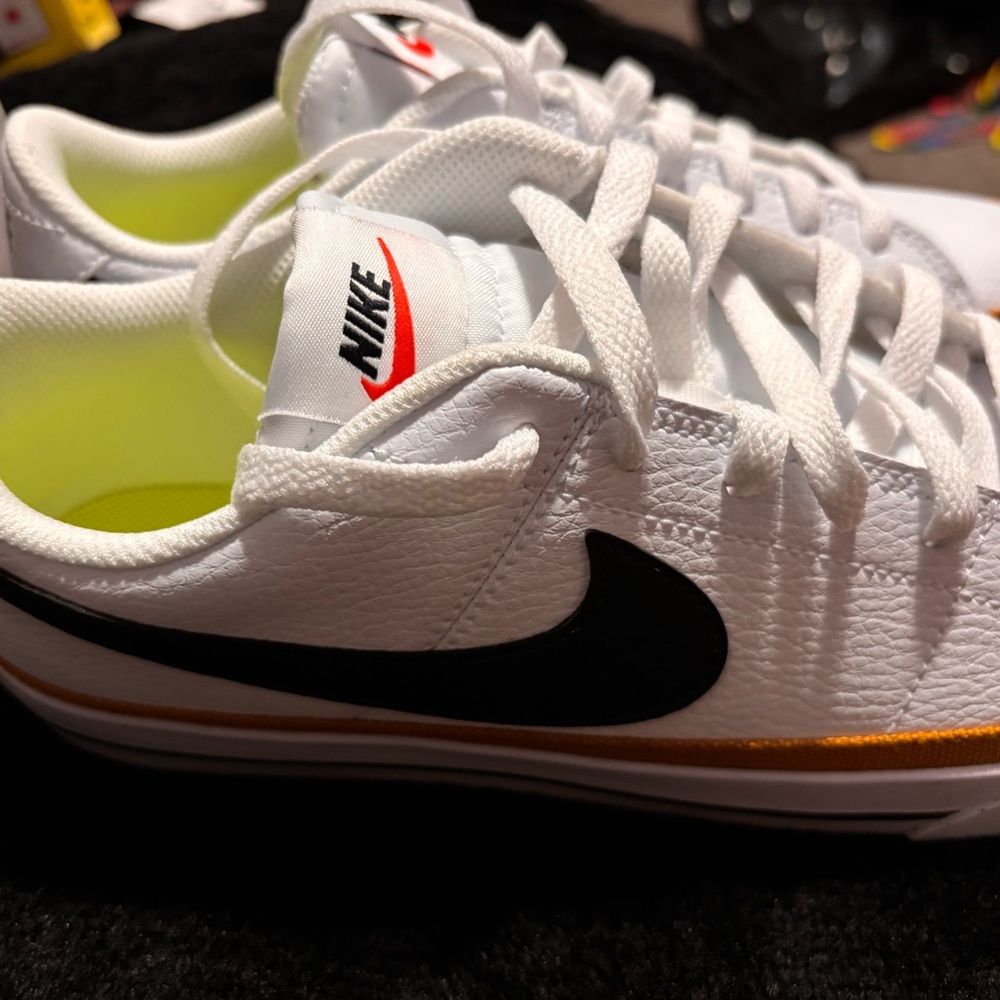 Nike White Low-Top Sneakers with Black Swoosh and Gold Accent - Picture 3 of 4